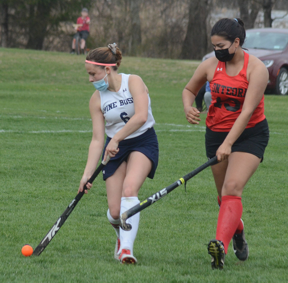 Pine Bush’s Alexandra Keith moves the ball as Onteora’s Isabella Solis defends during Friday’s MHAL field hockey game.